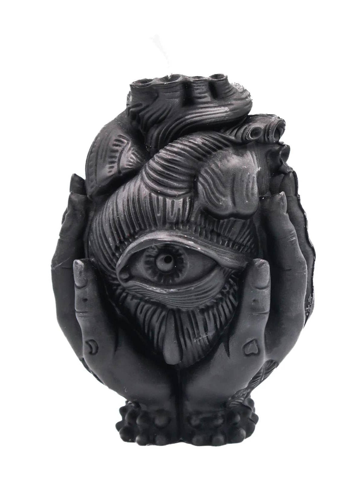 The Third Eye Heart Pillar Candle by A Pleasant Thought is a handcrafted candle shaped like an anatomical heart with a central eye, cradled by two hands at the base.