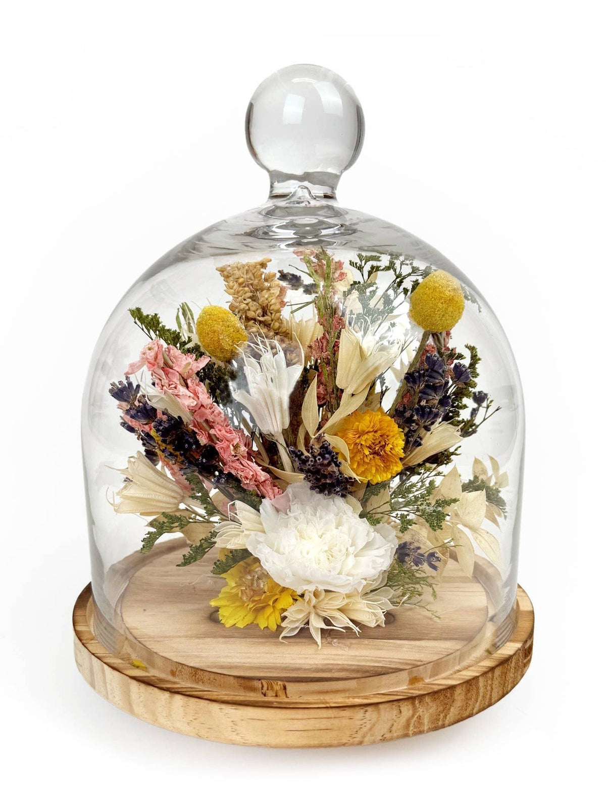 The Andaluca 10 White Carnation & Lavender Botanical Cloche features white carnations, lavender, and green foliage under a glass dome with a rounded handle on a wooden base—a charming home accent.