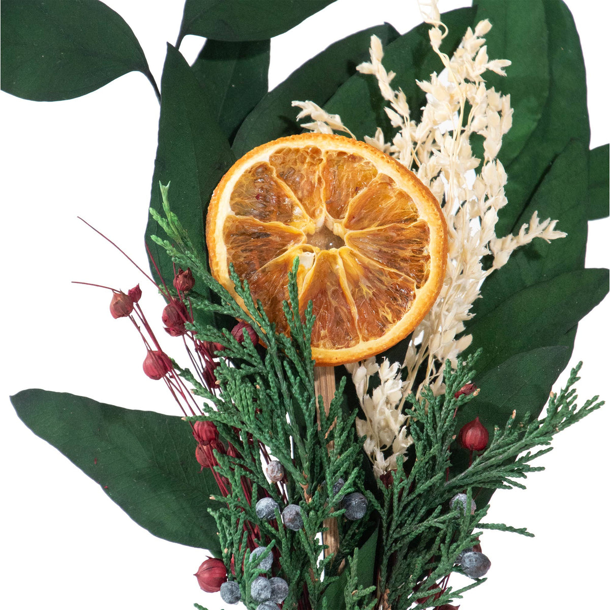 The Andaluca Winter Citrus Mini Bouquet features green leaves, white dried flowers, red and purple berries, and a natural orange slice, all beautifully arranged against a white background.