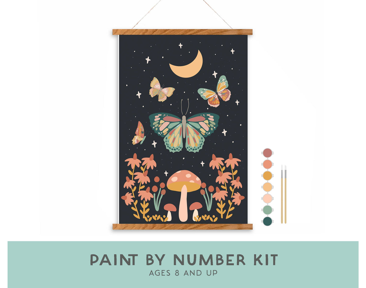 The Night Butterfly Garden Paint by Number Kit by Breathe People features mystical mushrooms, butterflies, flowers, a crescent moon, and stars. Includes paint pots and brushes. Ages 8+. Perfect for self care and relaxation.