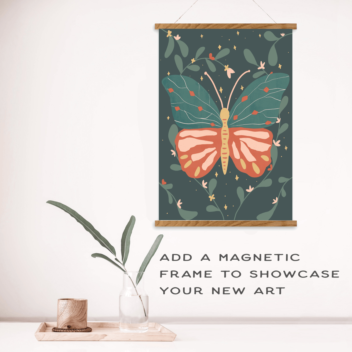 A Night Butterfly Paint by Number Kit art print by Breathe People hangs in a magnetic wooden frame above a table with a vase and leafy stem. Text reads: ADD A MAGNETIC FRAME TO SHOWCASE YOUR NEW ART.