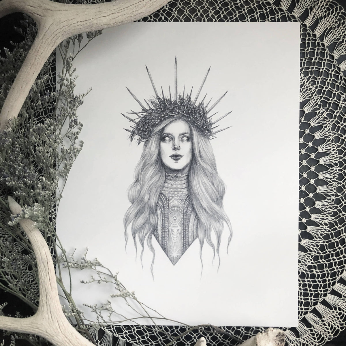 “Demeter” Fine Art Print by Caitlin McCarthy Art features a detailed black-and-white portrait of a crowned woman on a lace doily with antlers and foliage, available as a 10 x 8 archival matte print.