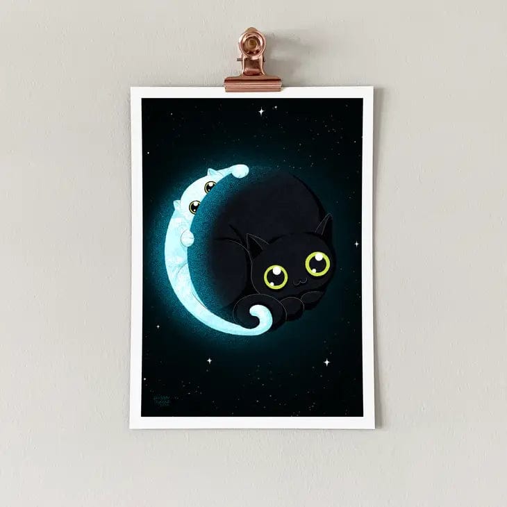 The Crescent Mewn Art Print (7 x 5) by Elissa Marie Creative features a cute black cat with green eyes curled on a crescent moon, as a glowing blue ghost cat peeks out amidst stars—capturing celestial magic.