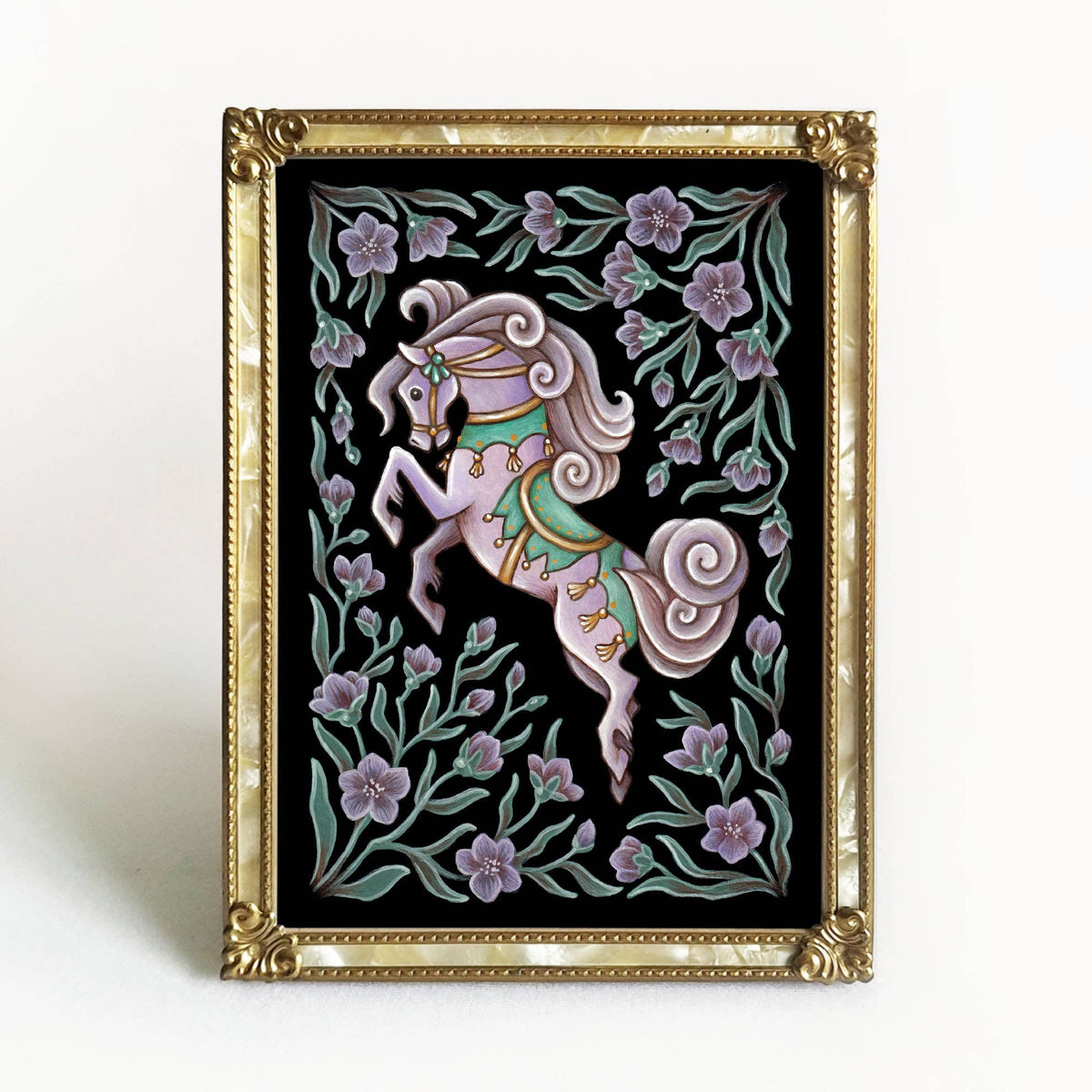 The Faina Lorah *Retiring* Horse Folk Art Print features a stylized white carousel horse with a purple mane, green saddle, and gold accents among lavender flowers and green leaves on black. Available in multiple sizes.