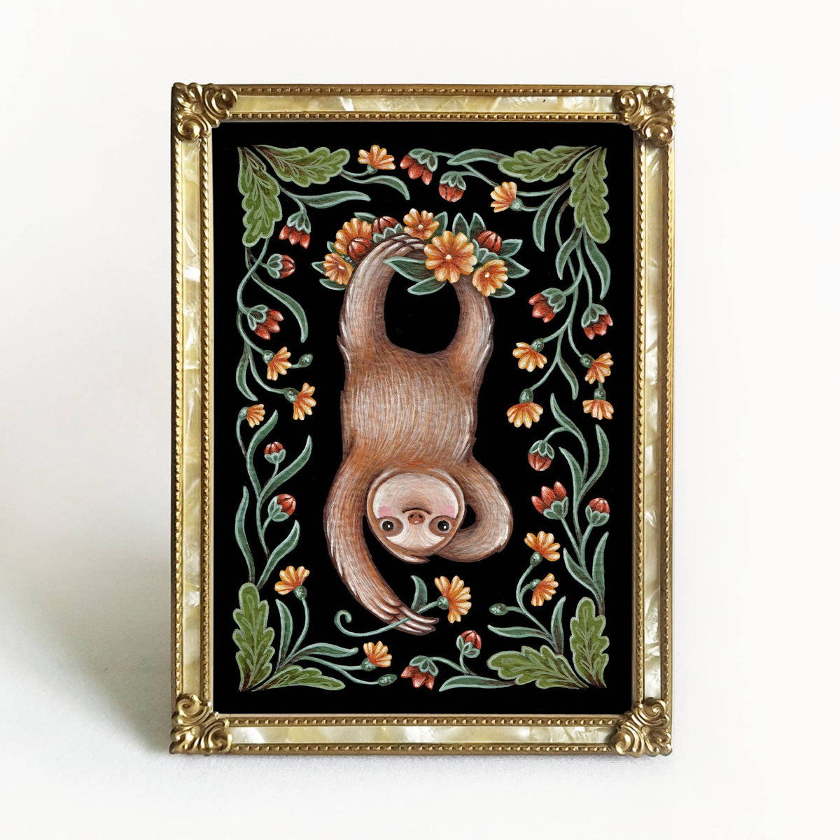 The *Retiring* Sloth Folk Art Print by Faina Lorah features a smiling sloth hanging upside down with orange and yellow flowers and green leaves on black, in an ornate gold frame. Available in multiple sizes.