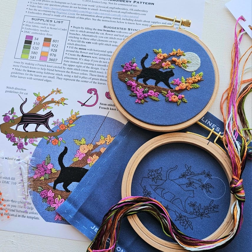 The 4 Beginner Mini Black Cats & Full Moon Embroidery Kit by Jessica Long Embroidery features a hoop with a black cat on a flowering branch, patterned thread, an instruction sheet, and is perfect for beginners.