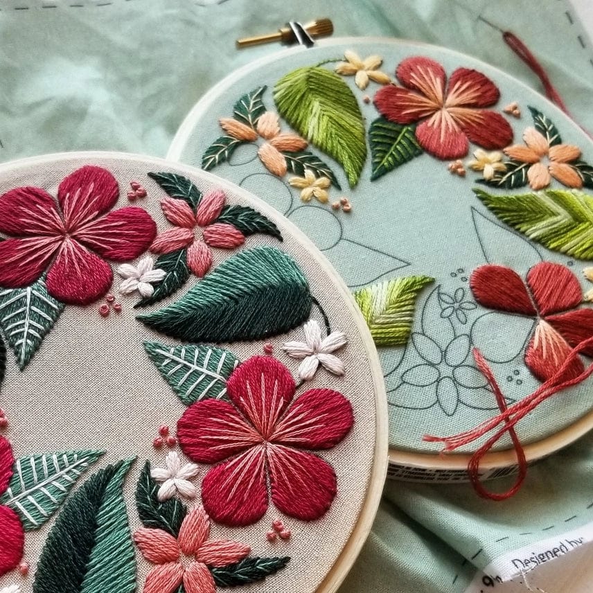 The *Late May Pre-order* 5 Beginner Green Floral Flourish Embroidery Kit by Jessica Long Embroidery features two hoops—one finished with red, pink, and white flowers and green leaves, the other partly stitched—perfect for creative floral projects.