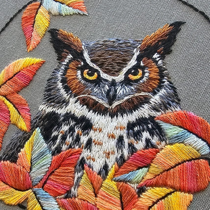 The *Late May Pre-Order* 5 Great Horned Owl Embroidery Kit by Jessica Long Embroidery features a vibrant, embroidered owl with yellow eyes and autumn leaves on gray fabric—ideal for kits or online video tutorials.