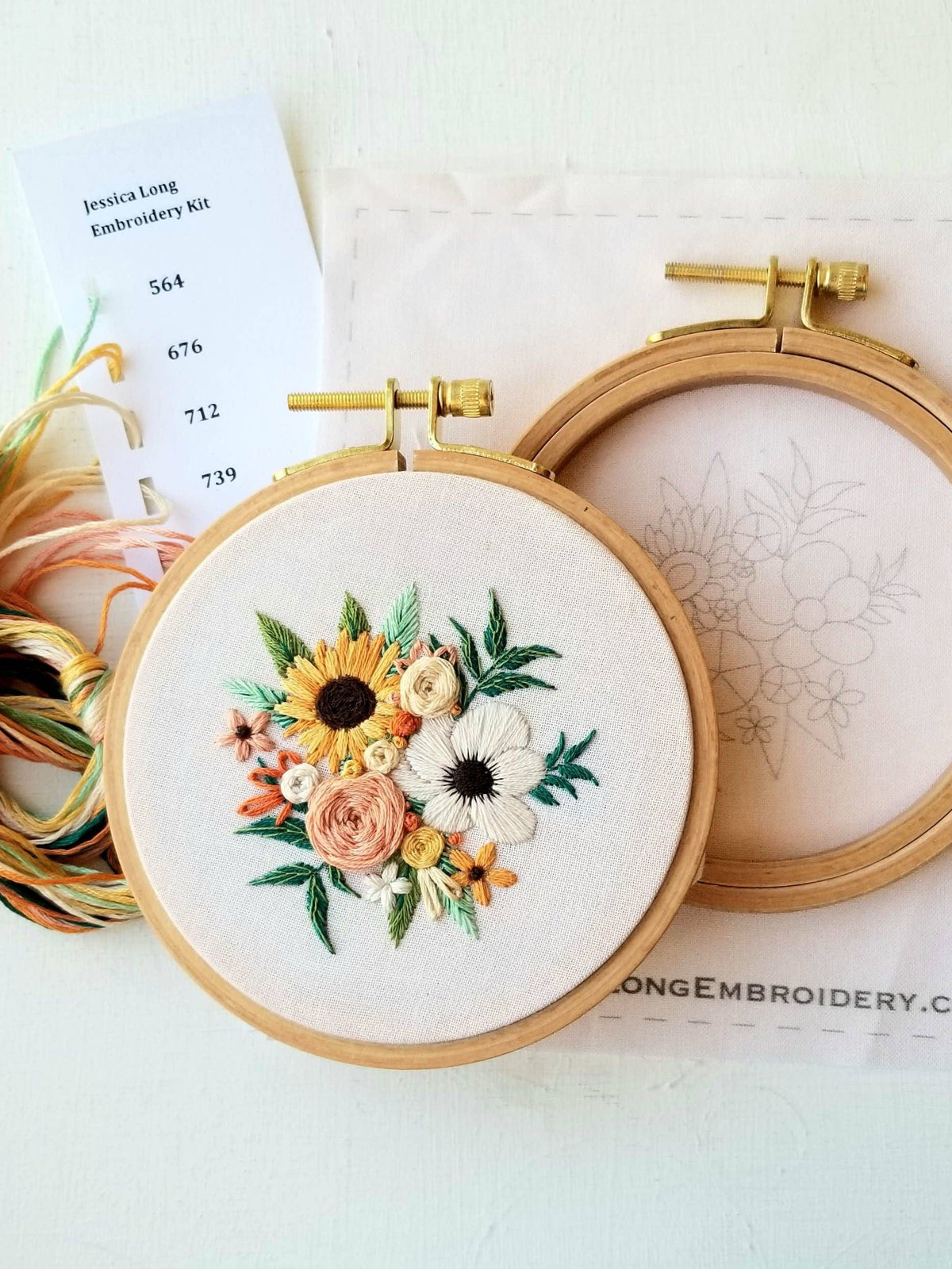 The Jessica Long Embroidery 4 Beginner Cozy Harvest Embroidery Kit features a hoop with a vibrant floral design, plus floss, needle, and pattern sheet with thread numbers—perfect for beginners.
