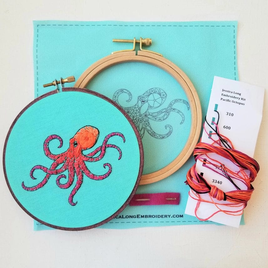 The Jessica Long Embroidery 5 Beginner Pacific Octopus Embroidery Kit includes turquoise fabric with a printed design, two hoops, colorful floss, and instructions—ideal for crafting unique ocean wall art or as a sea life craft kit.