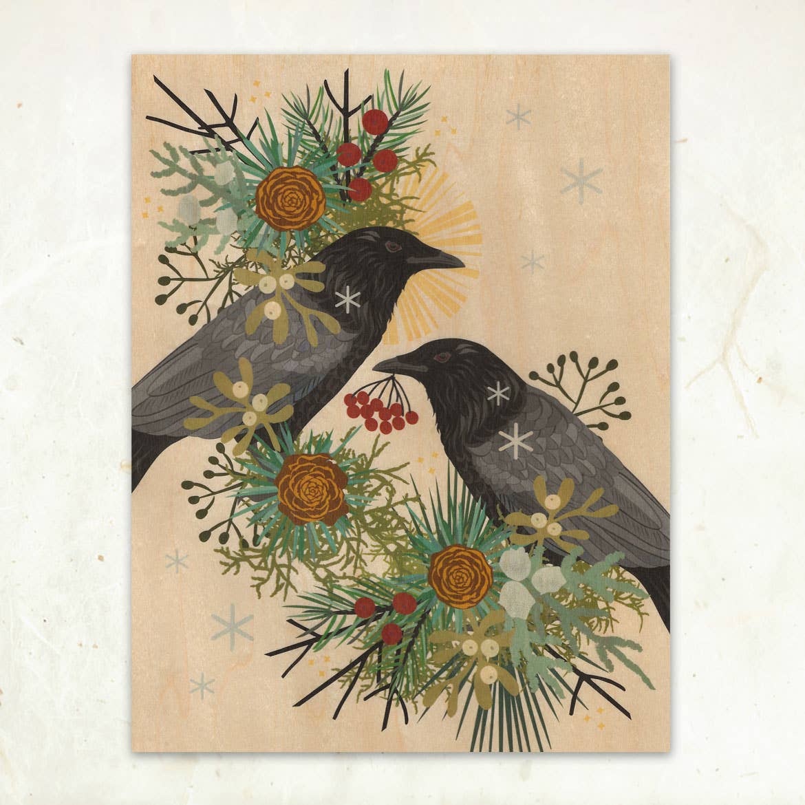 Winter Crows Small Wood Print (11x8.5) by Little Gold Fox Designs features two black crows amidst a festive wreath of pine, vibrant flowers, red berries, and greenery on light wood veneer; one crow holds red berries in its beak.