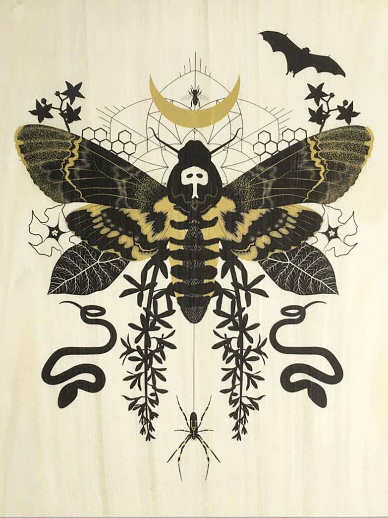 The Hawk Moth Small Wood Print (11 x 8.5) by Little Gold Fox Designs features a symmetrical black and gold death’s-head hawkmoth with skull pattern, plants, bat, snakes, spider, and crescent moon in a biodegradable sleeve.