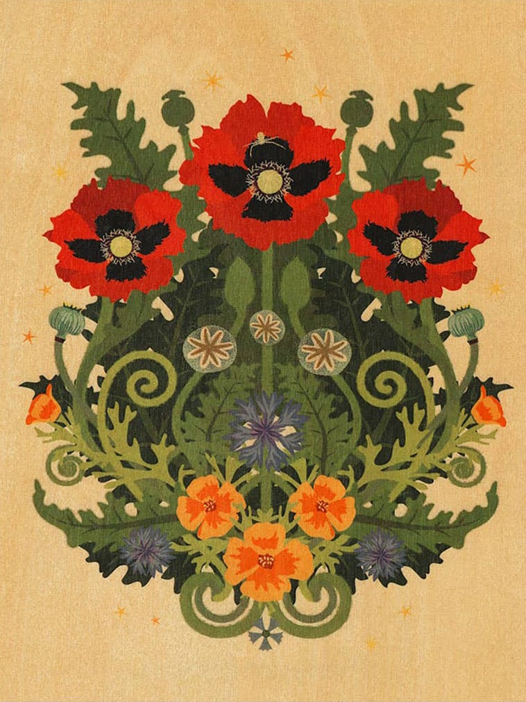 The Poppy Spider Small Wood Print (11 x 8.5) by Little Gold Fox Designs shows three red poppies, green leaves, and blue blossoms arranged symmetrically on biodegradable wood veneer with a beige background and yellow stars.