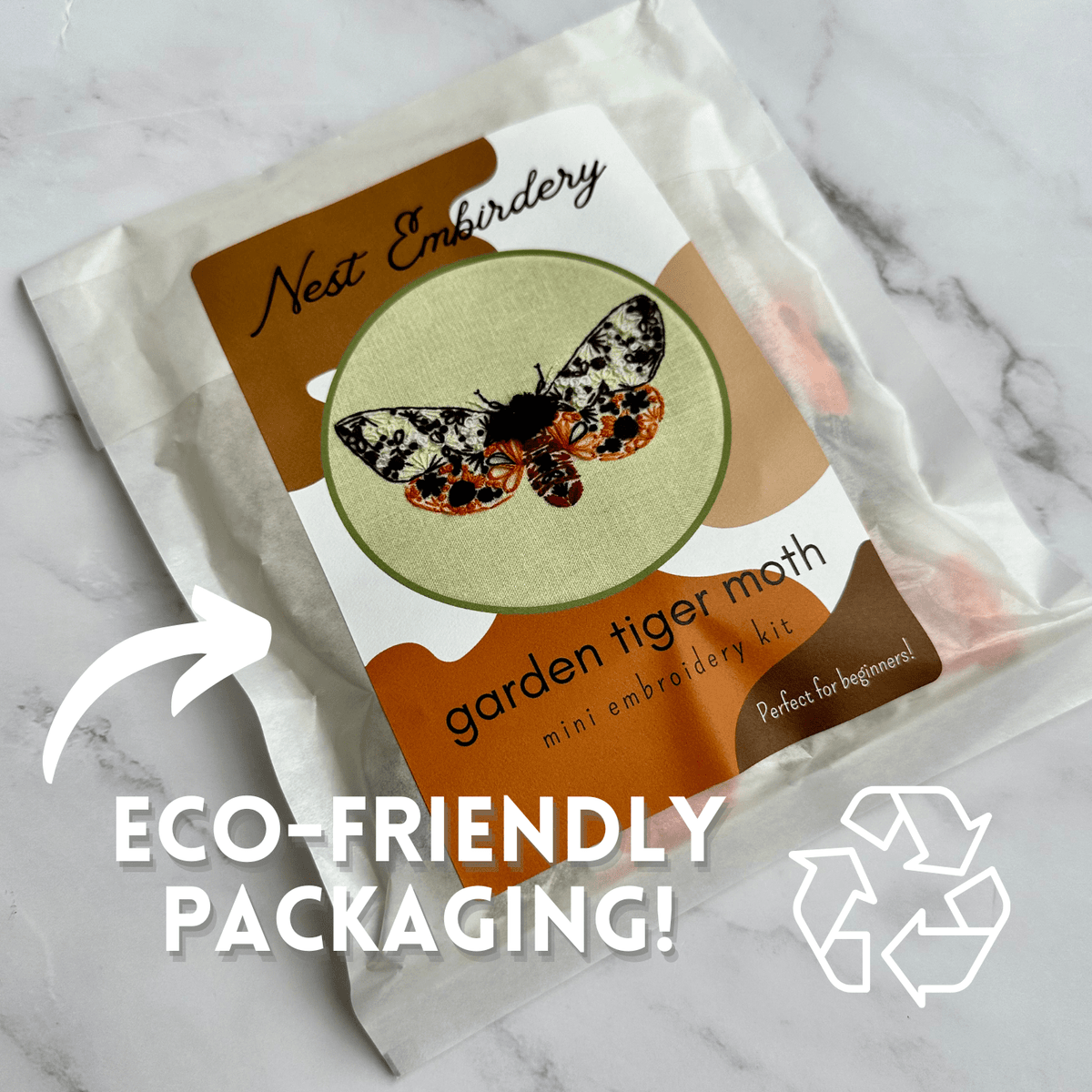 The 4 Beginner Garden Tiger Moth Embroidery Kit by Nest Embirdery comes in a white, eco-friendly bag and features charming insect details, making it perfect for DIY embroidery beginners.