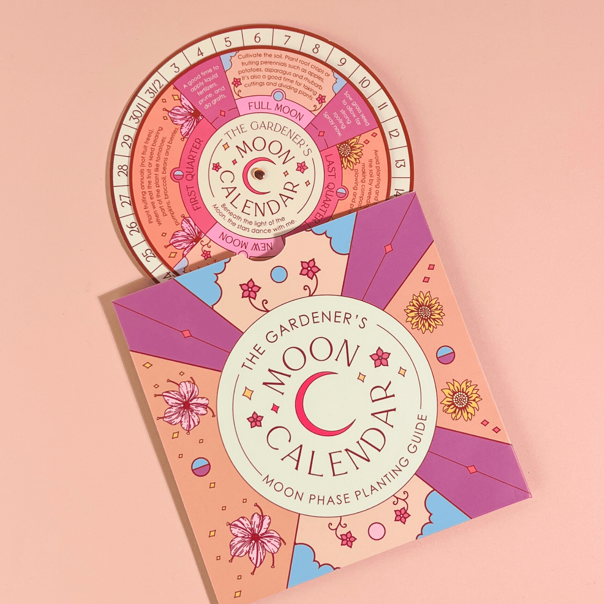 The Sow the Magic Moon Phase Calendar Spinner Planting Guide features a rotating wheel, illustrated flowers, and moon phases on a light pink background—ideal for gardeners who follow lunar cycles.