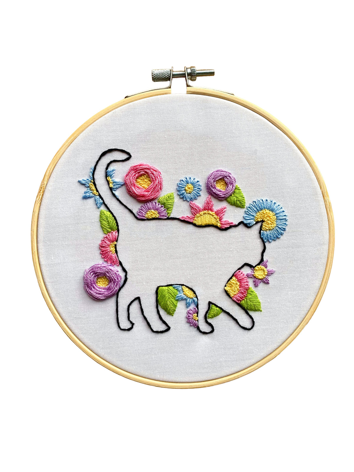 The Stitches By Tiff 6 Beginner Cat in Bloom Silhouette Sampler Embroidery Kit features a black cat outline filled with floral sampler designs on white fabric—a charming DIY art project for embroidery enthusiasts.