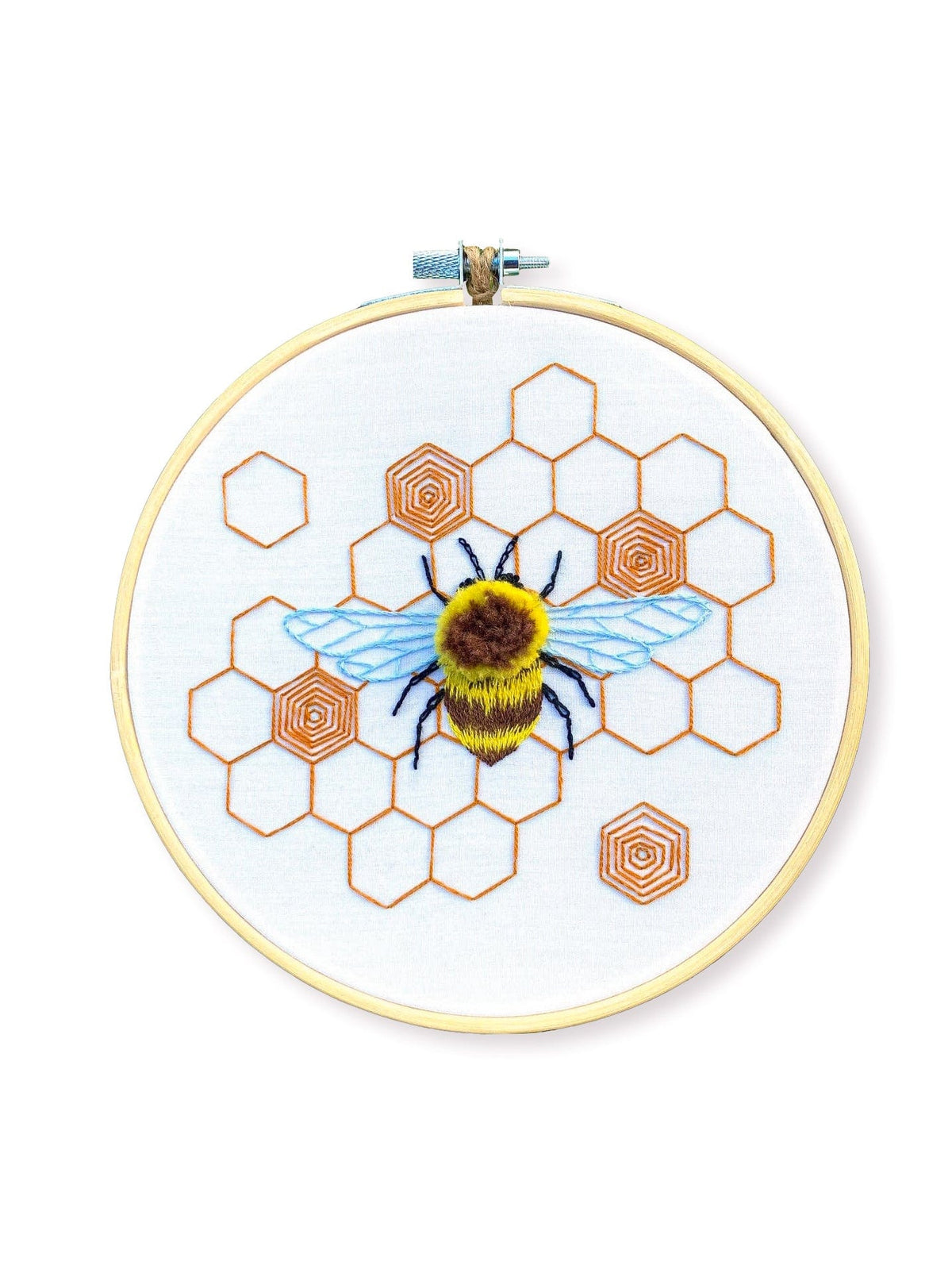The Stitches By Tiff 6 Fuzzy Bumblebee DIY Embroidery Kit features a stitched bee with blue wings, a yellow and black body, and orange honeycomb patterns—ideal for beginner stitchers seeking a fun art project.