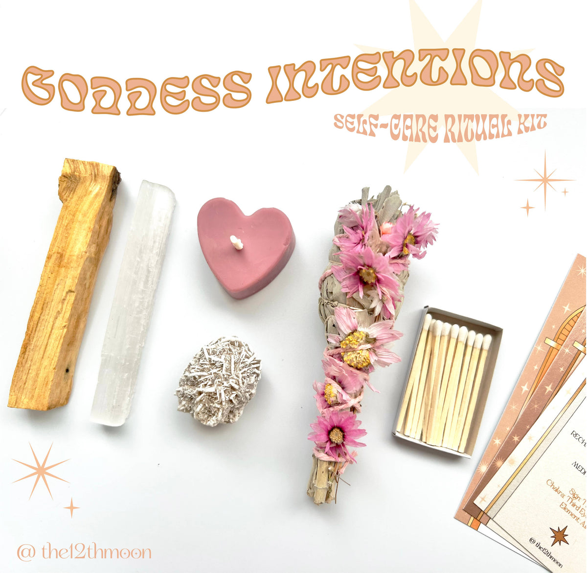 A flat lay of The 12th Moons Goddess Intentions Self-Care Ritual Kit featuring Palo Santo, selenite, a pink heart candle, a crystal, Prairie Sage Bundle with pink flowers, matches, and ritual instruction cards on a white background.