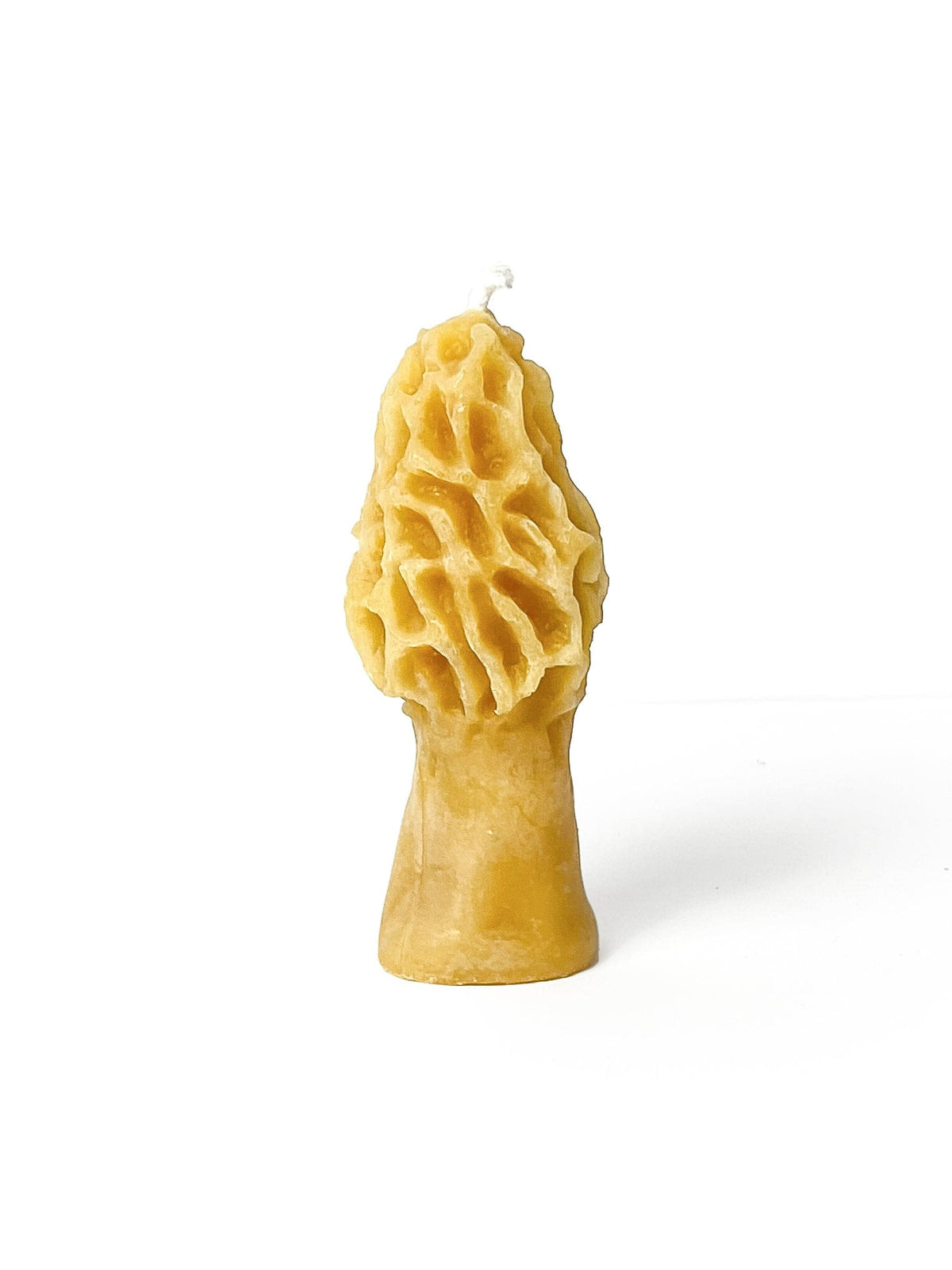 The Ramblin Bees Mini Morel Mushroom Beeswax Candle, crafted from pure beeswax and eco-friendly packaging, features a yellow, ridged morel mushroom shape with a wick on top, displayed against a white background.
