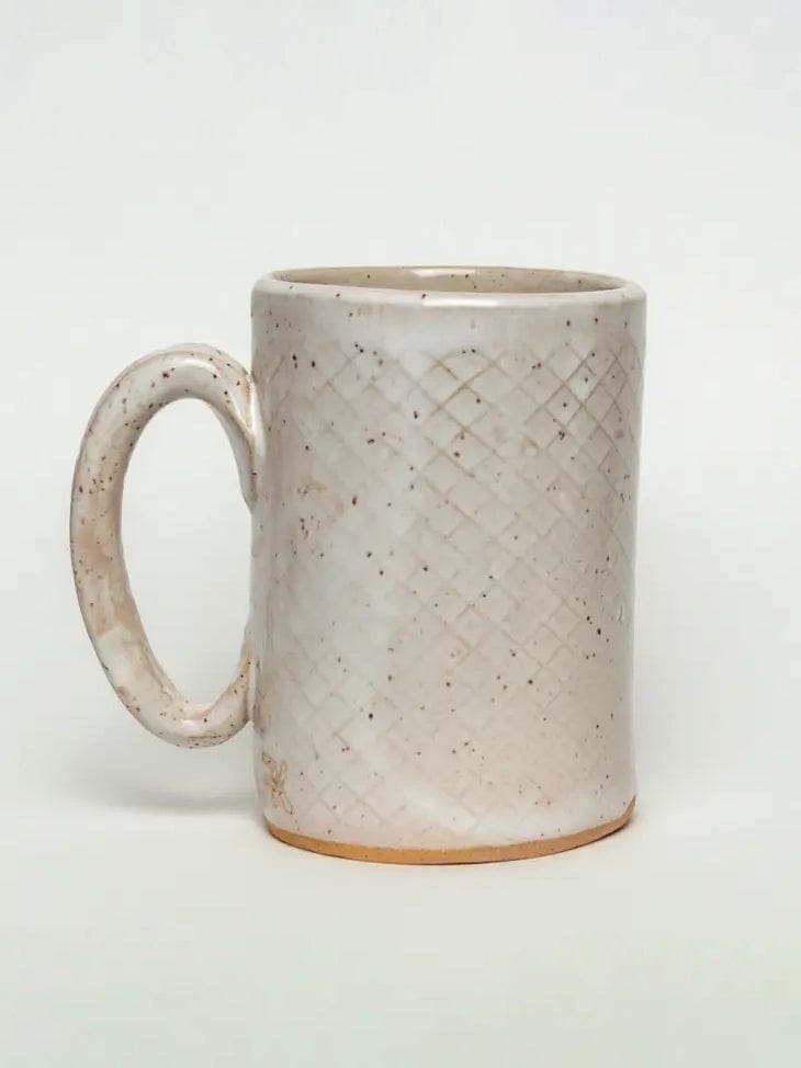 The Chickadee Design Handmade Ceramic Mug by White Squirrel Clayworks features a large handle, textured crisscross pattern, speckled off-white glaze, and exposed natural clay base. Shown on a plain white background. 16oz capacity.